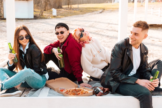 Group of happy friends having fun on picnic