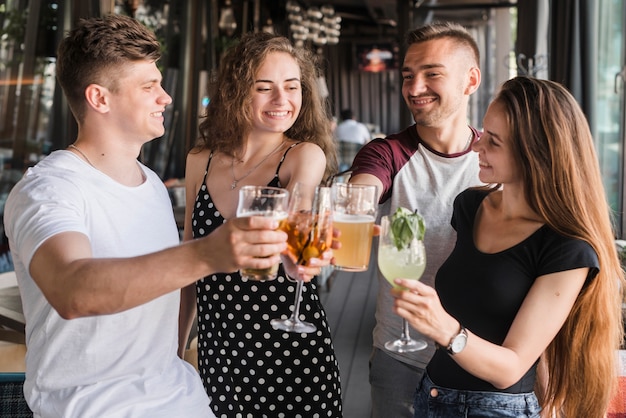 Free photo group of happy friends holding set of drinks