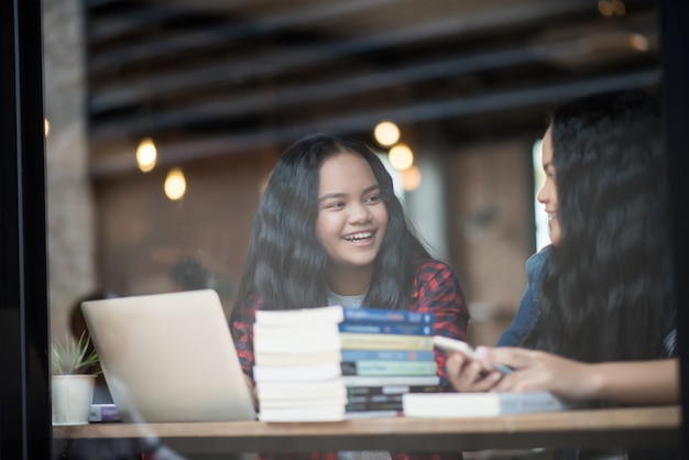 Group of happy friends student talking about knowledge in cafe