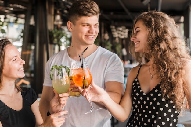 Group of happy friends toasting drinks