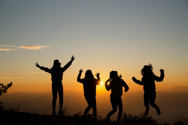 Free photo group of happy young people jumping on the hill. young women enjoying