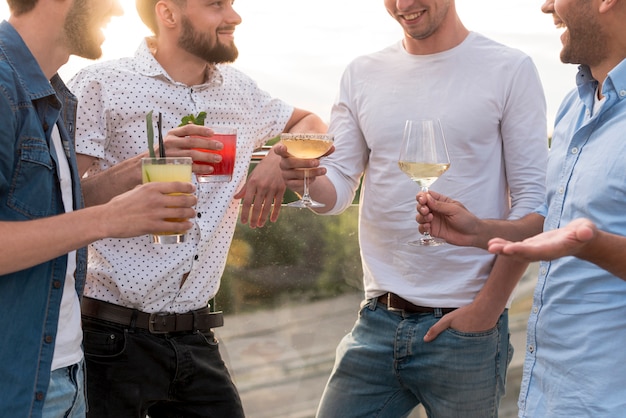 Free photo group of men discussing at a terrace party