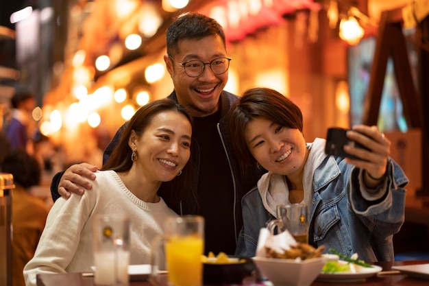 Group of middle age friends having fun at night