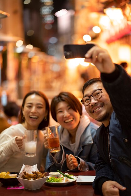 Group of middle age friends having fun at night