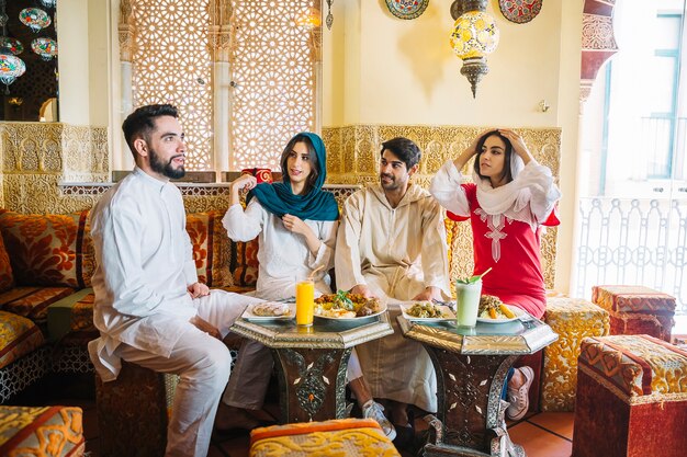 Group of muslim friends in restaurant