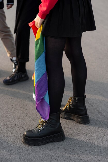 Group of non binary people with rainbow flag