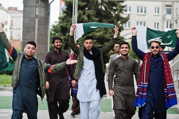 Free Photo group of pakistani man wearing traditional clothes salwar kameez or kurta with pakistan flags