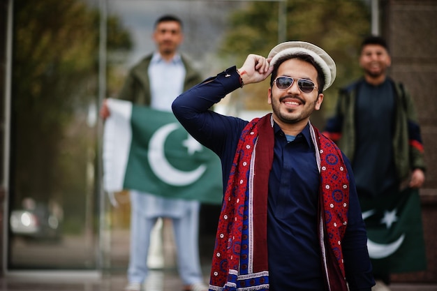 Free Photo group of pakistani man wearing traditional clothes salwar kameez or kurta with pakistan flags