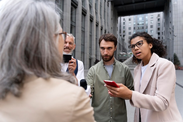 Free photo group of people doing a journalism interview