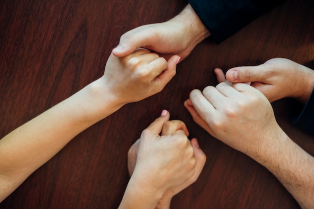 Group of people holding each other hands