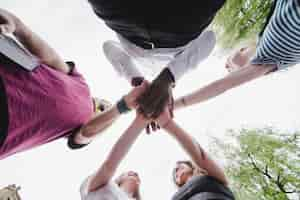 Free photo group of people holding hands together