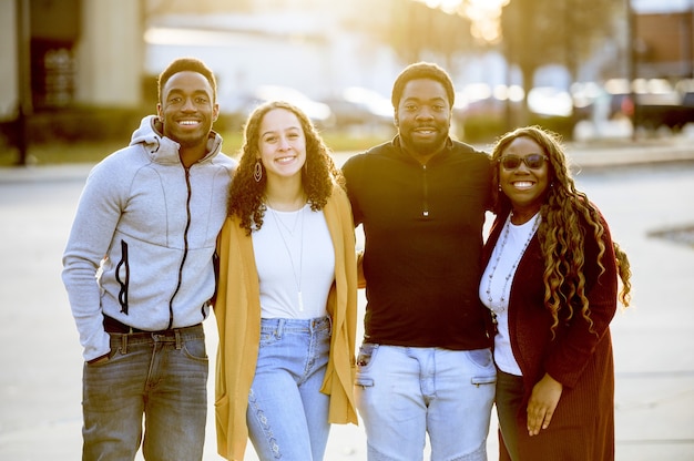 Group of people standing in a park under sunlight with a blurry