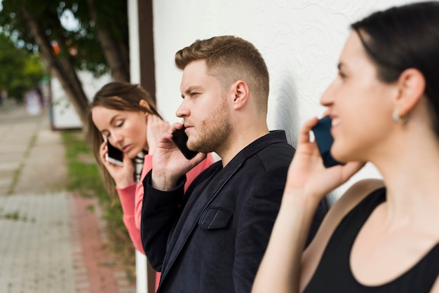 Group of people talking on phones outdoors