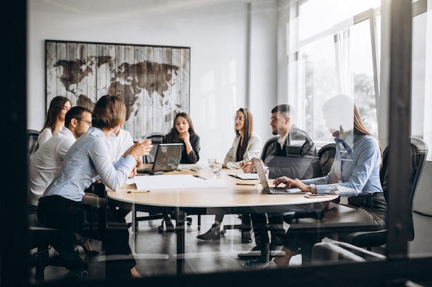 Free photo group of people working out business plan in an office