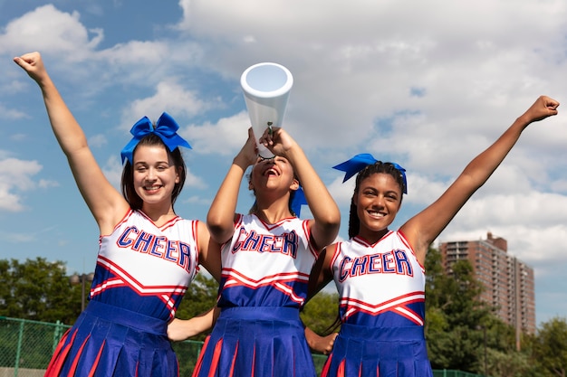 Free Photo group of pretty teenagers in cheerleader uniforms