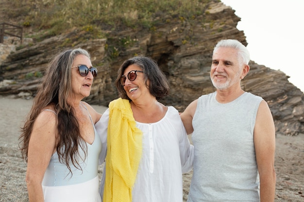 Group of senior friends spending time together at the beach