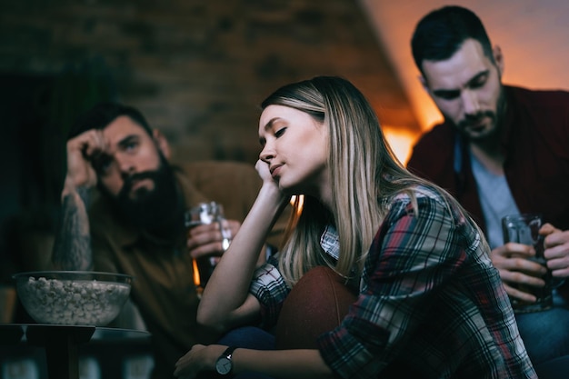 Free photo group of sport fans feeling sad after their team has lost a game focus is on woman