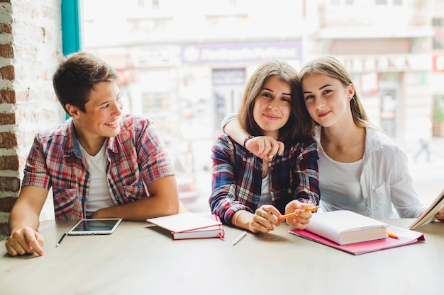 Free photo group of students with books at table