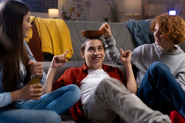 Group of teenage friends having snacks at home together