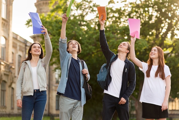 Free photo group of teenagers happy to be back at university