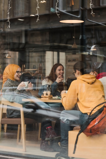 Free photo group of teenagers having a coffee