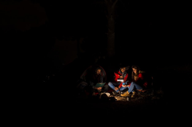 Free Photo group of three friend camping at night