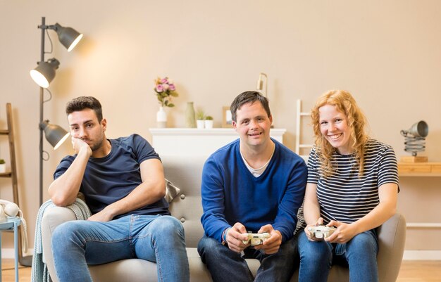 Group of three  friends having playing video games at home