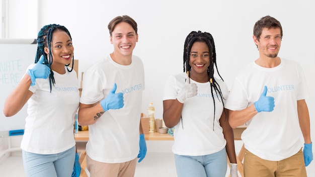 Group of volunteers doing the thumbs up sign