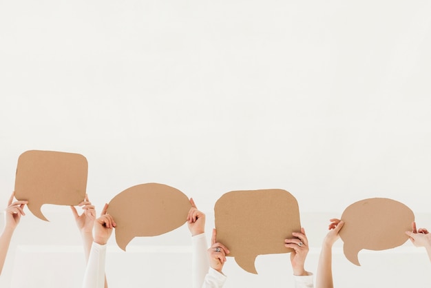 Group of women hands holding chat bubbles