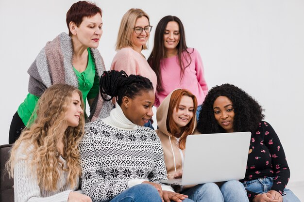 Group of women looking through a laptop together