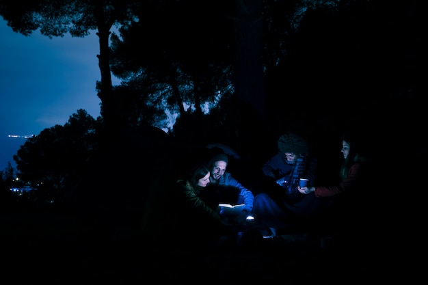 Free photo group of young couple hiker night camping in mountains