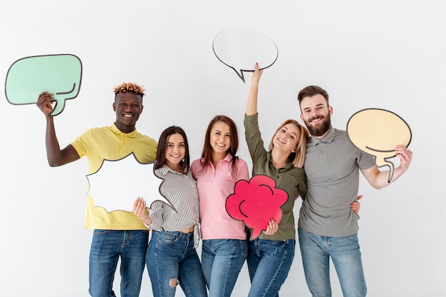 Free photo group of young friends holding chat bubble