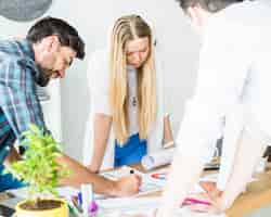 Free photo group of young male and female architect working in office