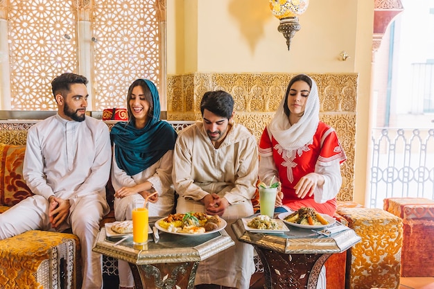 Group of young muslim friends in restaurant