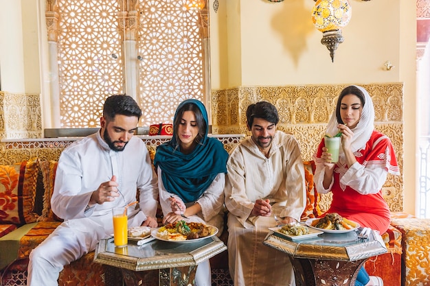 Group of young muslim friends in restaurant