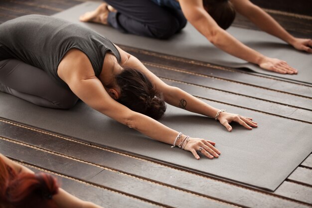 Group of young people in Balasana pose