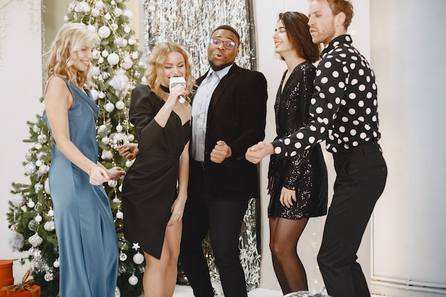 Group of young people celebrating new year. Friends drinks champagne.