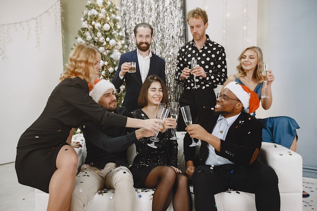 Group of young people celebrating new year. Friends drinks champagne.