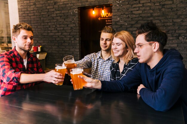 Group of young people cheering at bar restaurant