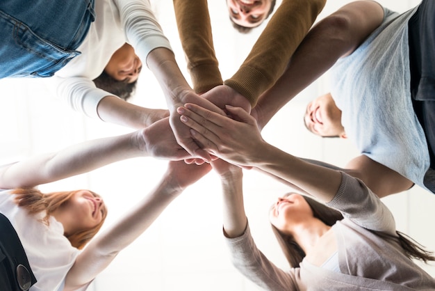 Free Photo group of young people holding hands