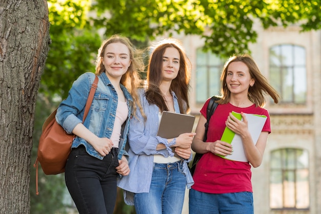 Group of young students in front of school building