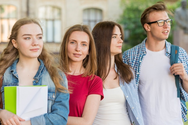 Group of young students in front of school building