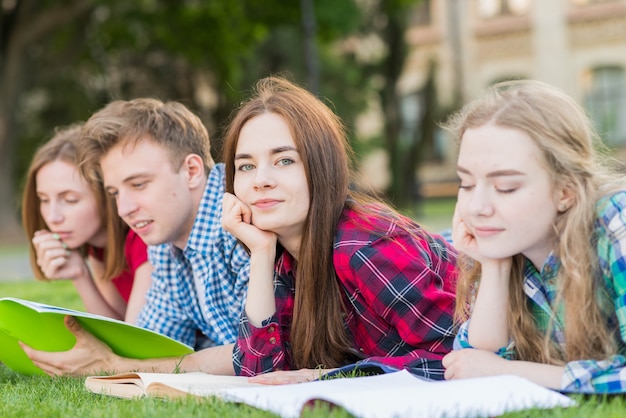 Group of young students learning in park