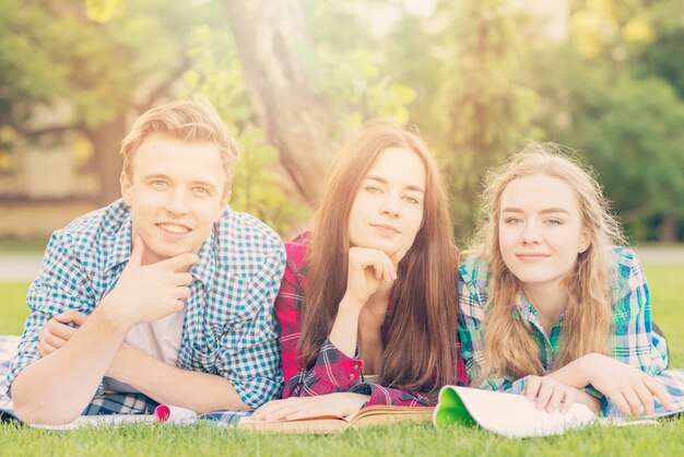 Group of young students learning in park