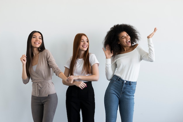 Free photo group of young women cheering together