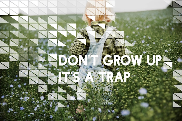 Free photo don't grow up it's a trap flower field child