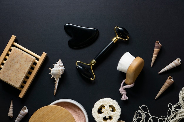 Free photo gua sha and wooden items arrangement flat lay