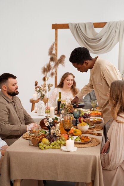 Guests attending wedding and eating at the table