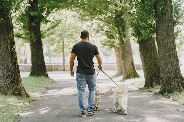 Guide dog helping blind man in the city. Handsome blind guy have rest with golden retriever in the city.