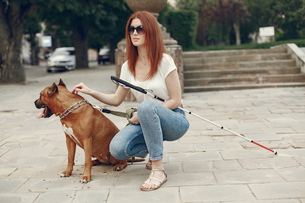 Guide dog helping blind woman in park